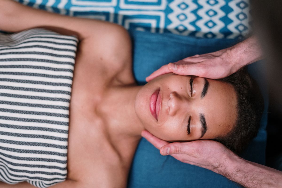 Head massage during a facial treatment, stock photograph